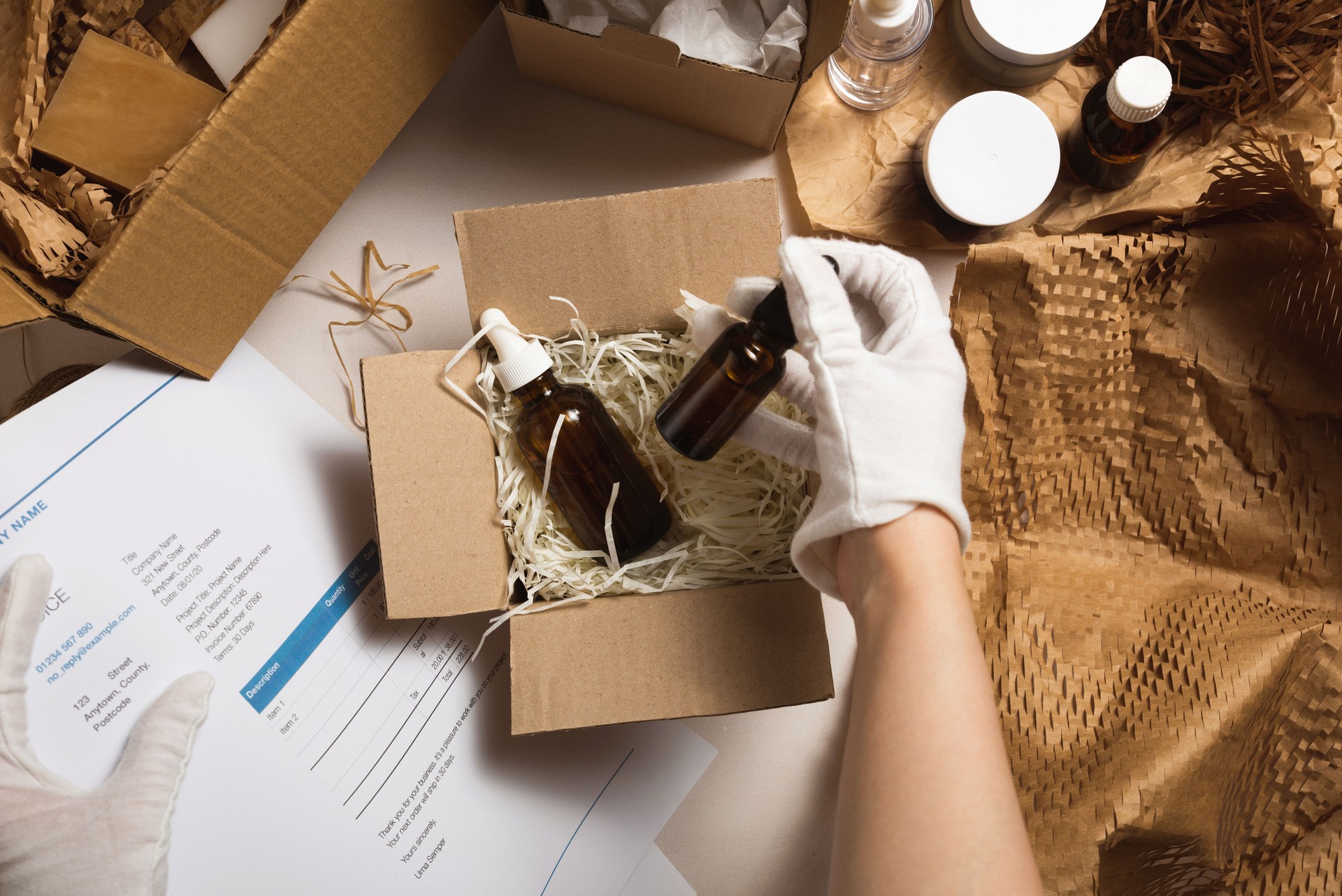 Beauty box with serum bottles on shredded white paper